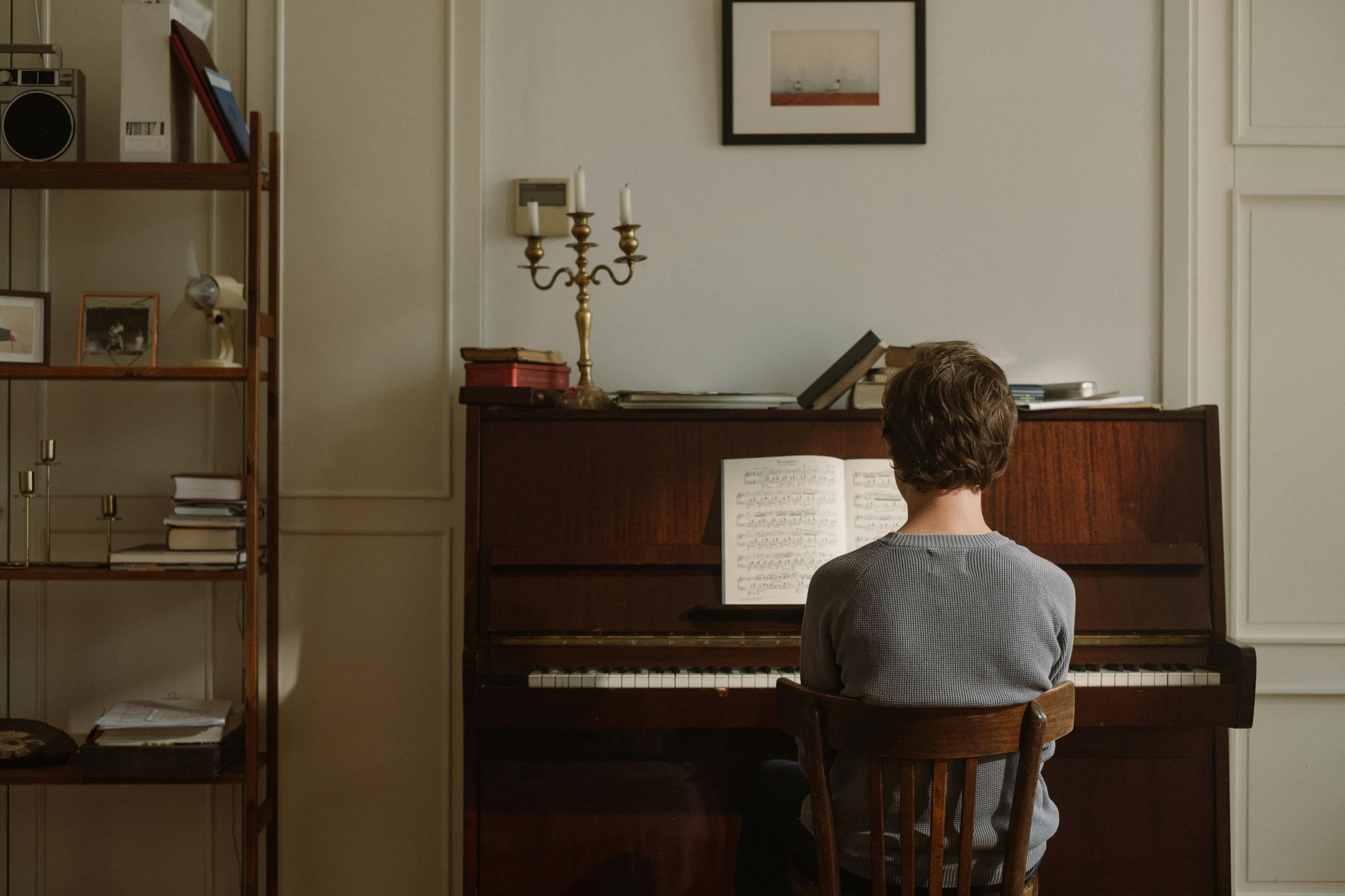 A child playing piano, lost in the music